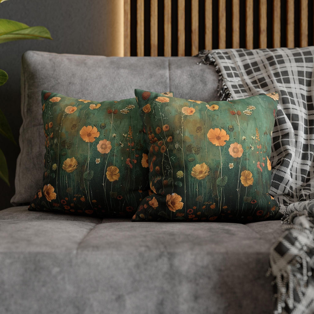 two pillows on a couch with a plant in the background
